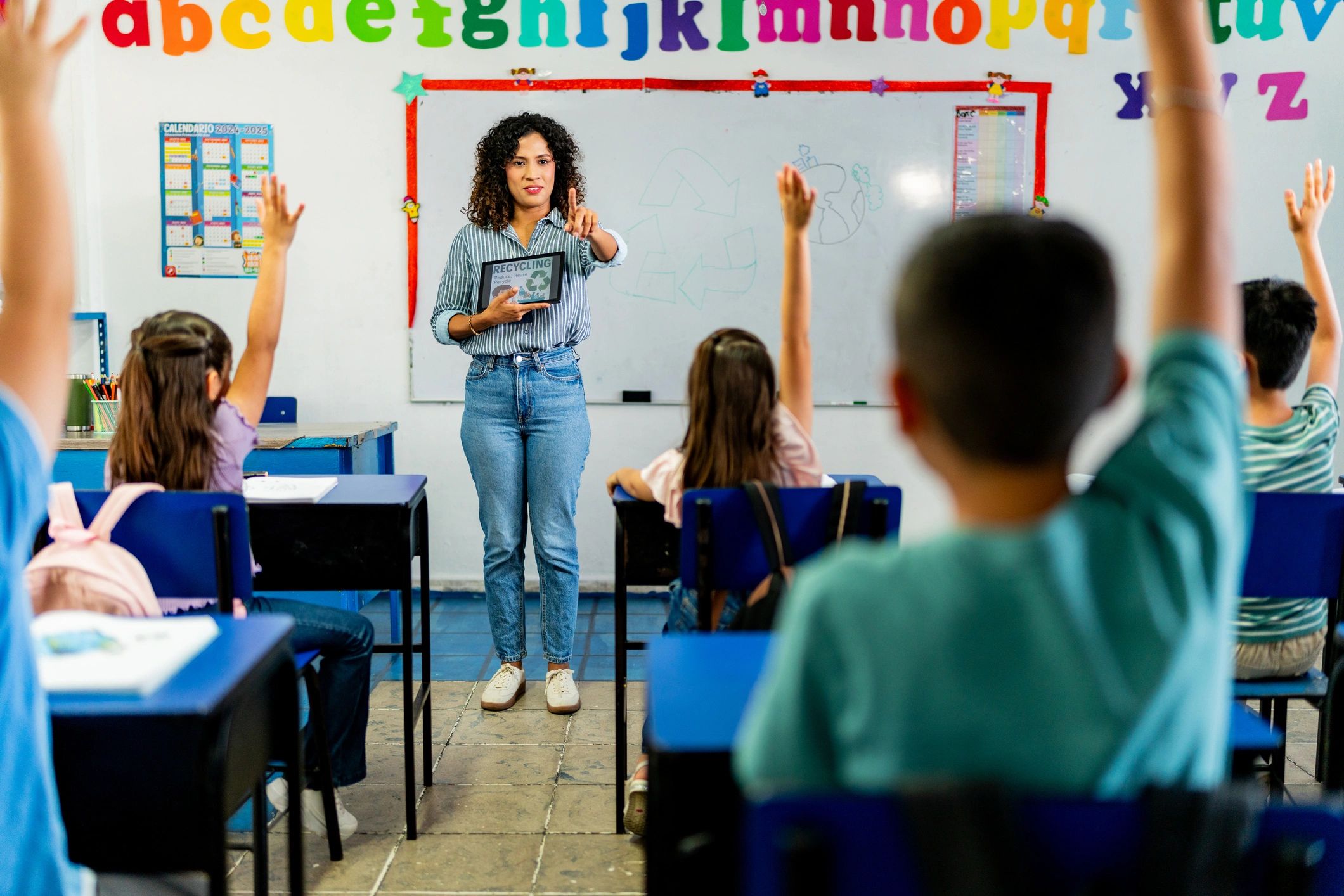 Teacher guiding young students during class